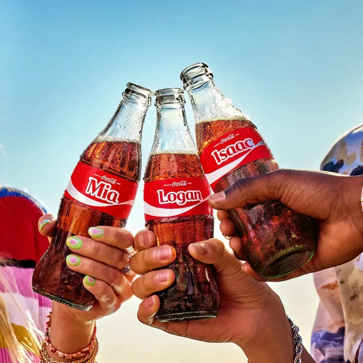 Coke bottles with names on packaging